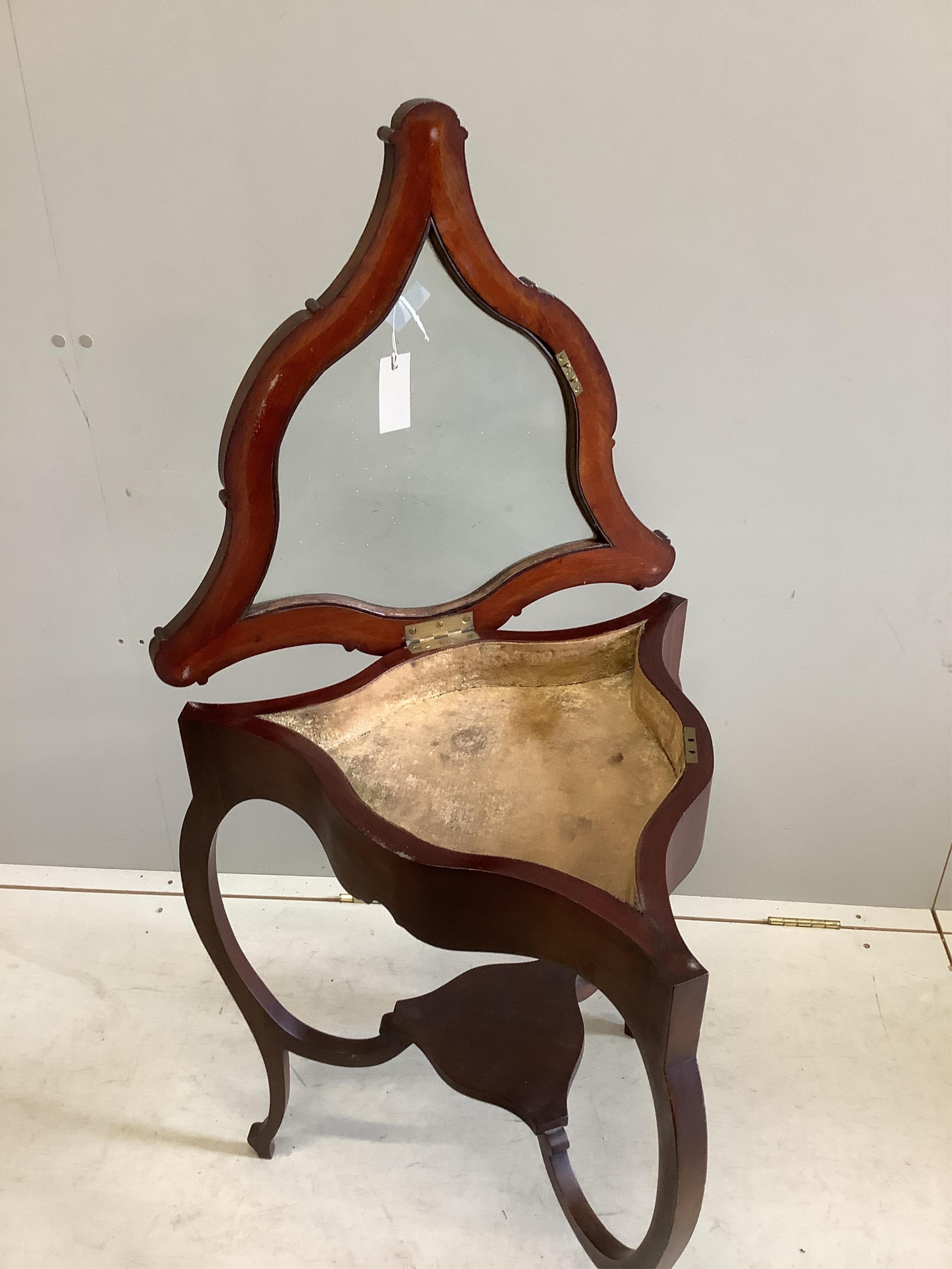 A late Victorian triangular mahogany bijouterie table, width 52cm, height 74cm. Condition - fair